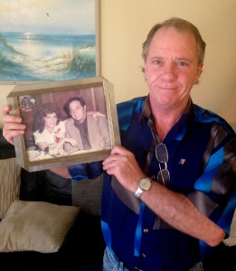 James Vassallo holds a photo of his parents, Albert Vassallo Sr. and Geraldine Mickey Vassallo. (John Pacenti/The Palm Beach Post)